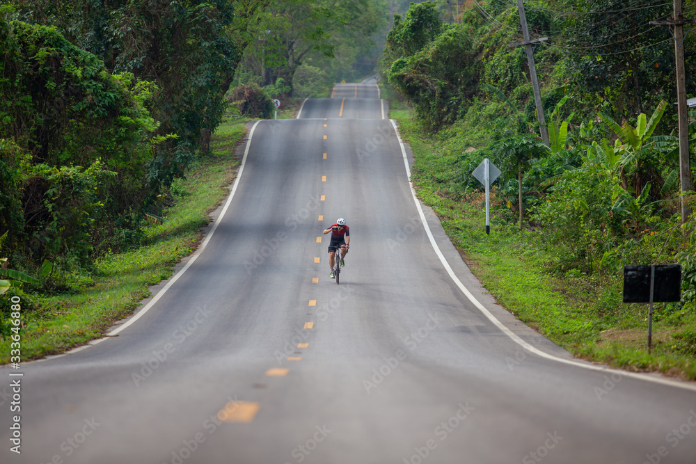 Alone young sportsman action the cyclist road bicycle Alone young sportsman action the cyclist road bicycle
