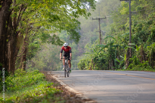 Young sportsman action the cyclist road bicycle