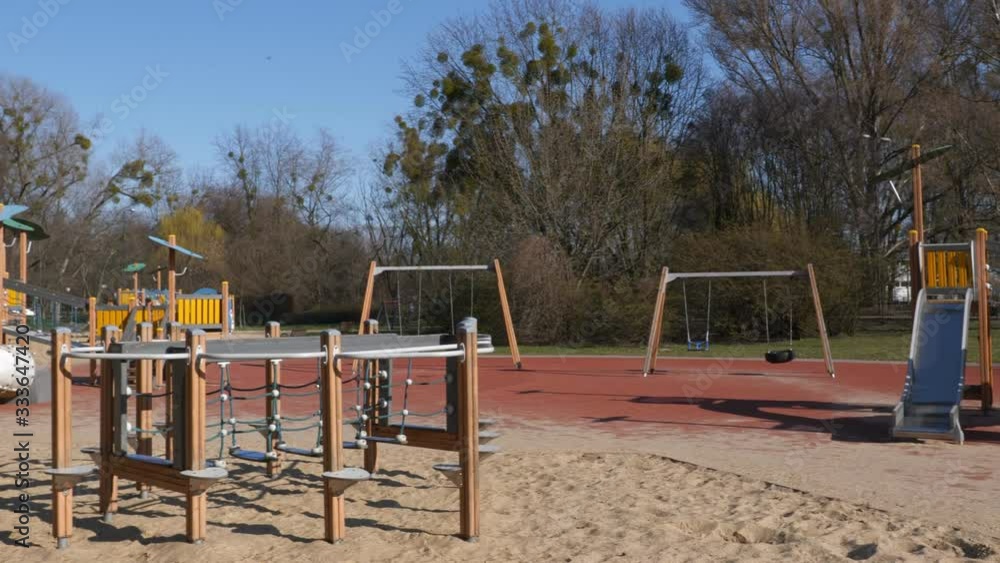 Empty public playground for children in urban park, panning to left Empty public playground for children in urban park, panning to left