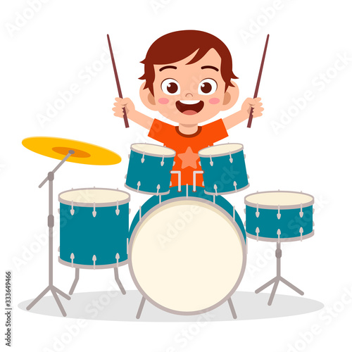 happy cute little kid boy playing drum