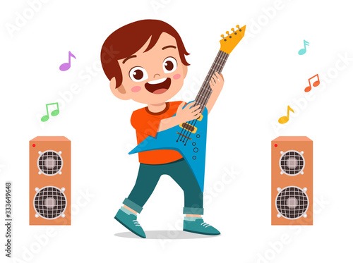 happy cute little kid boy play guitar