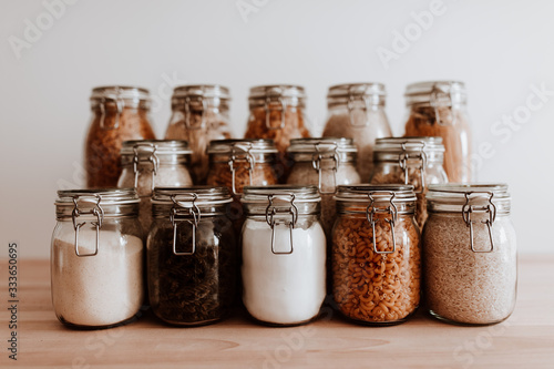 Konstfotografi Glass jars full with dried uncooked food ingredients