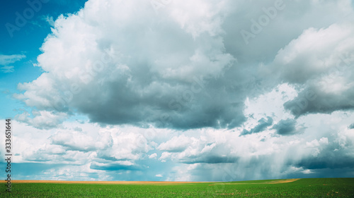 Amazing Natural Bright Dramatic Sky With Rain Clouds Above Countryside Rural Field Meadow Landscape In Spring Summer Cloudy Day. Scenic Sky With Fluffy Clouds On Horizon. Beauty In Nature