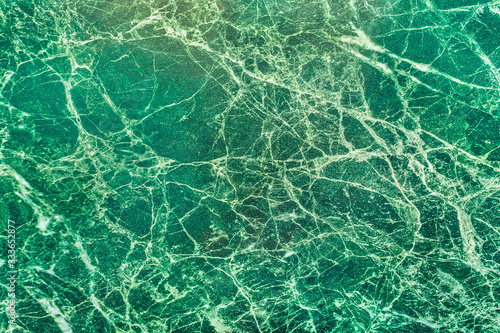 Green malachite surface texture with abstract pattern, background