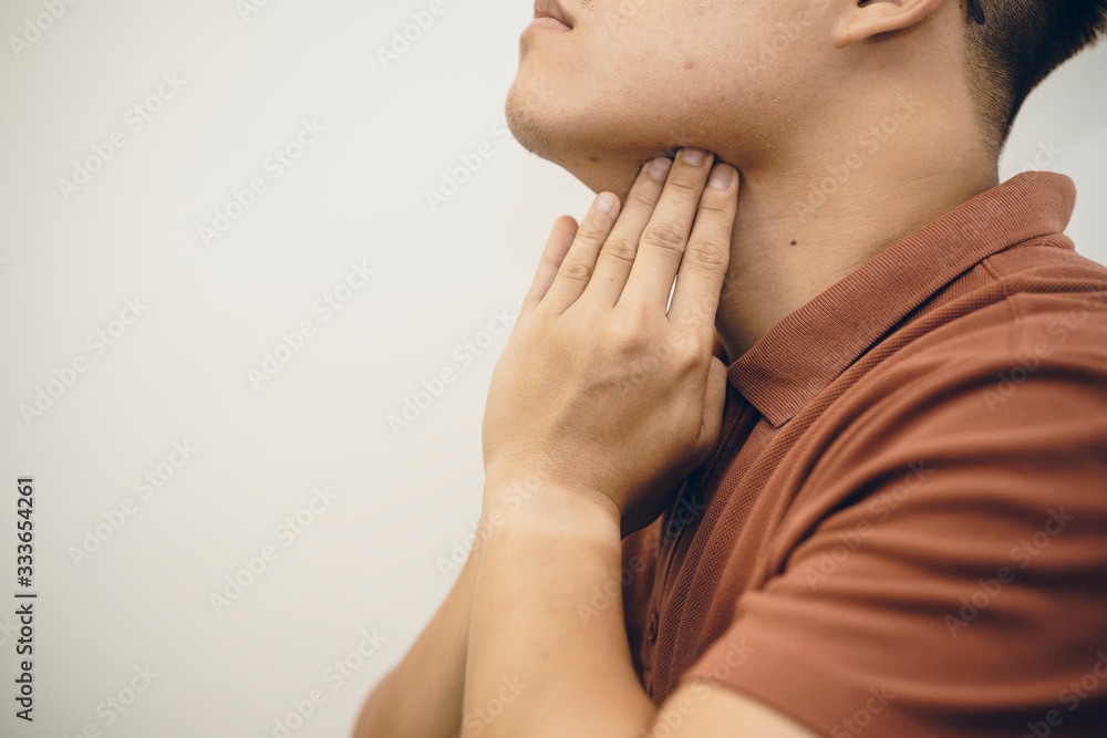 Young Asian Man in hygienic mask suffering sore throat and having flu, 2019-nCoV or coronavirus. Airborne respiratory illness such as pm 2.5 fighting. Studio shot isolated on white background Young Asian Man in hygienic mask suffering sore throat and having flu, 2019-nCoV or coronavirus. Airborne respiratory illness such as pm 2.5 fighting. Studio shot isolated on white background