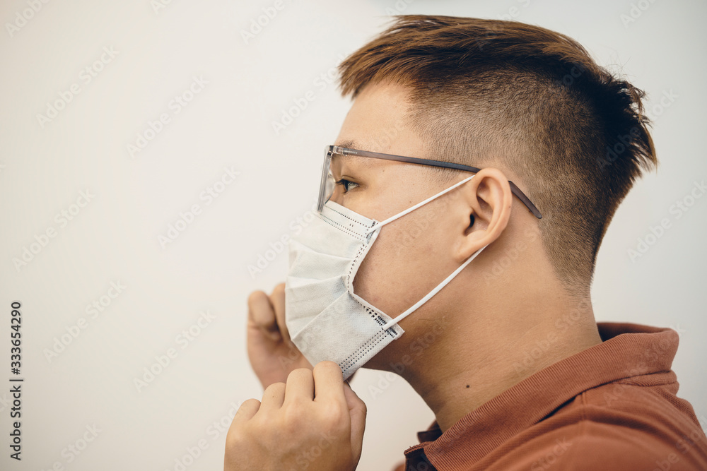 Protection against coronavirus in workplace. Asian man wearing medical mask