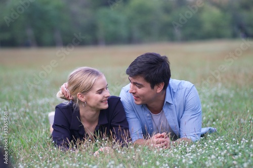 European couples, men and women Showing love to each other in the garden. During the holidays, warm and comfortable holidays in the fields and large trees. Who are planning a marriage