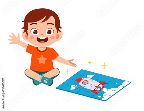 happy cute little kid boy play jigsaw puzzle
