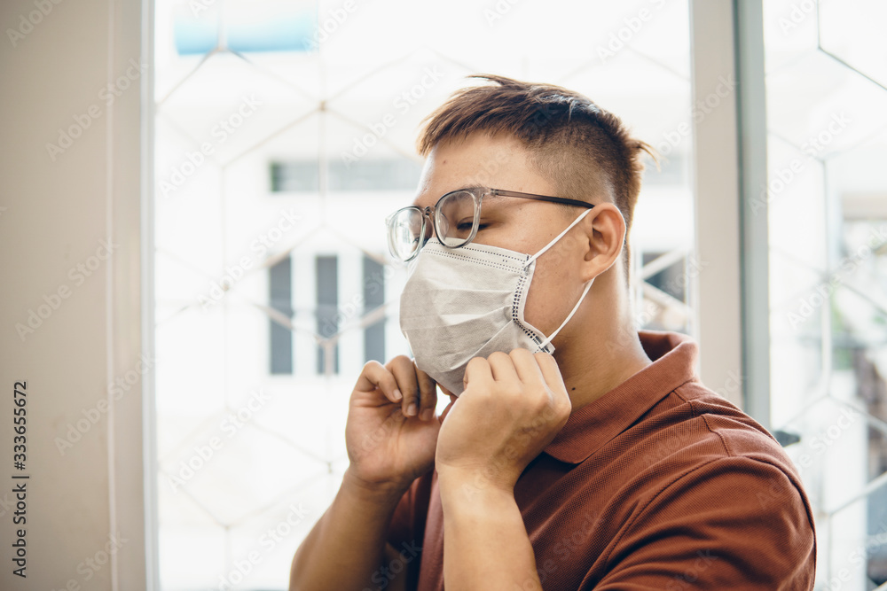 Protection against coronavirus in workplace. Young asian man wearing medical mask