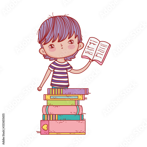 little boy holding open book stacked books