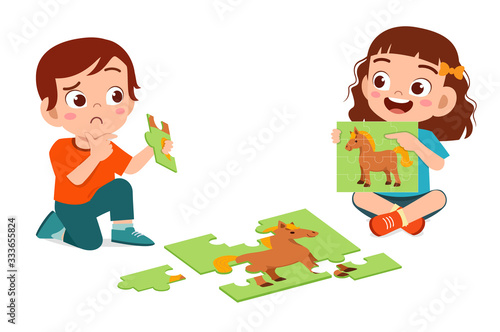 happy cute little kid boy and girl play jigsaw puzzle