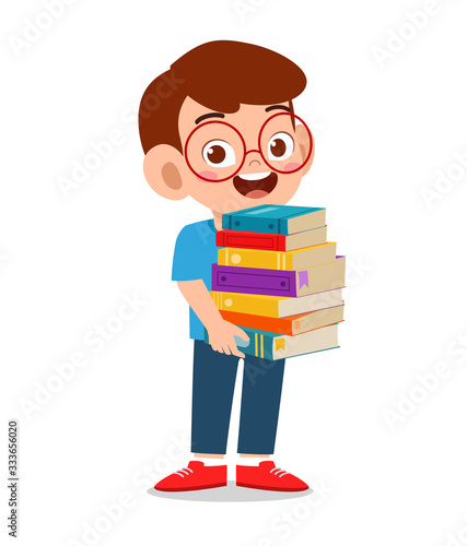 happy cute little kid boy carry pile of books