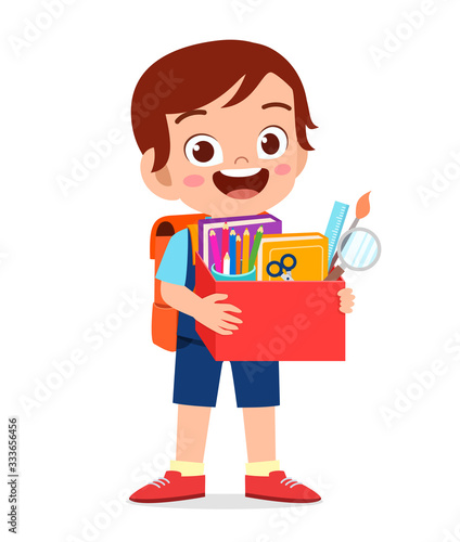 happy cute little kid boy carry box of school supplies