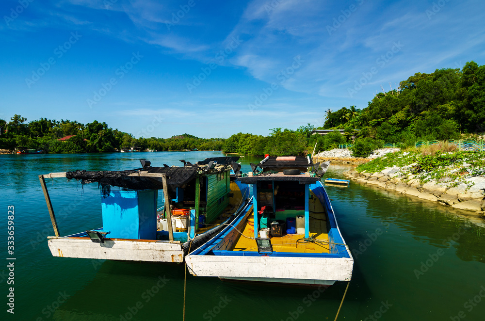 beauty in nature, traditional fisherman boat at Terengganu, Malaysia beach under bright sunny day and blue sky