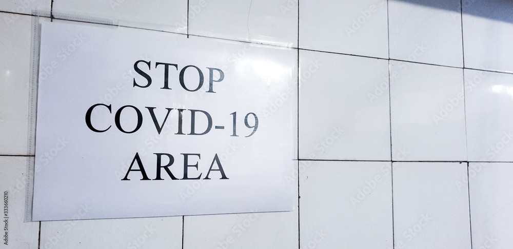 Sign informing about coronavirus disease on white ceramic plates. It is supposed to prevent more infections of dangerous flu-like coronavirus disease in hospitals Sign informing about coronavirus disease on white ceramic plates. It is supposed to prevent more infections of dangerous flu-like coronavirus disease in hospitals