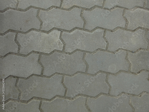 gray laid curbstone shaped tiles under your feet