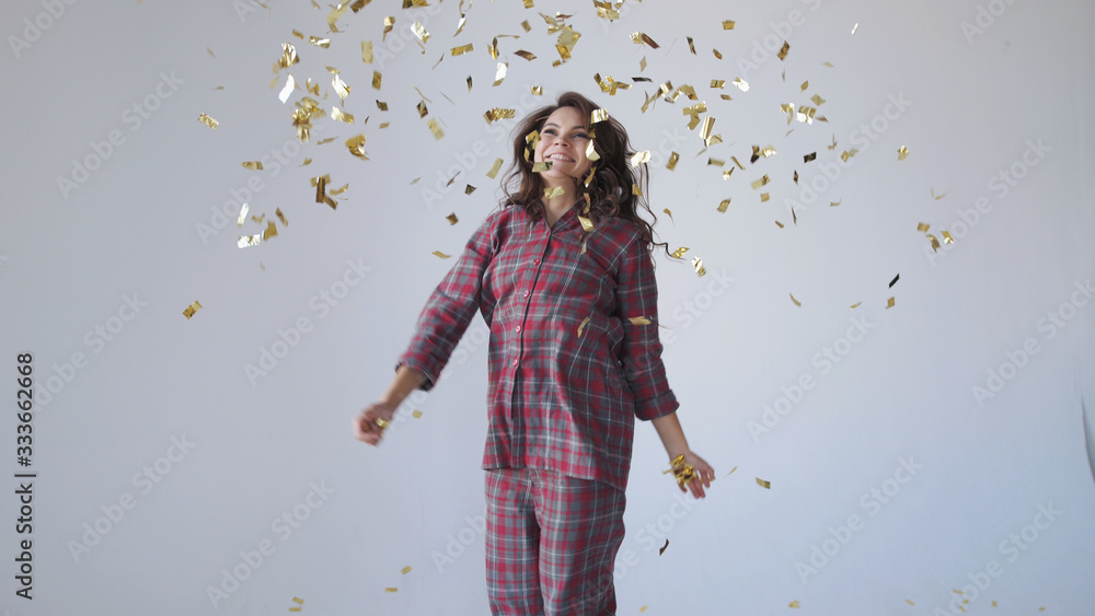 Beautiful woman dancing and throwing gold confetti. Beautiful woman dancing and throwing gold confetti.