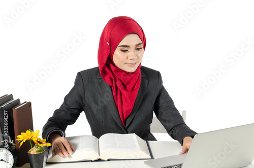 young businesswomen or student in hijab sitting and look at her laptop against white background