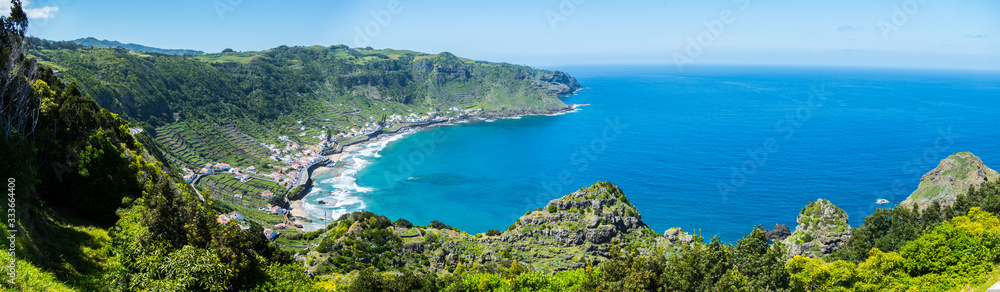 Panorama on the Azores Island Santa Maria - Bay with a small village, coast line and the blue ocean on a sunny 