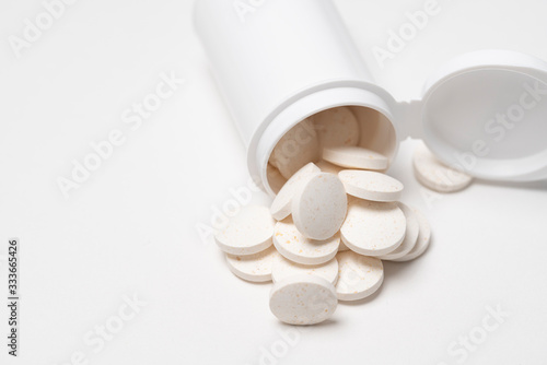 Pills and medicine on white surface, isolated medicine. Medicine and Vitamins for better health and healthcare. Copy space on left side