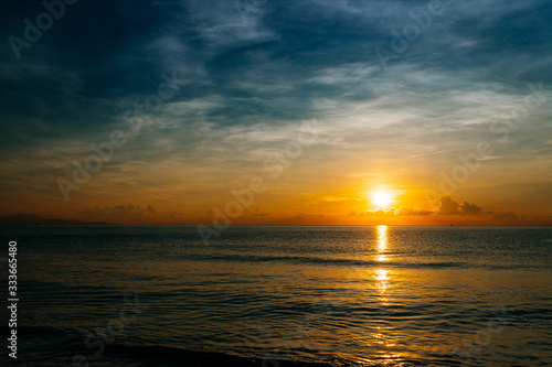 Fototapeta Naklejka Na Ścianę i Meble -  Sunrise, sunset of the sun through the clouds, tropical area near  sea.