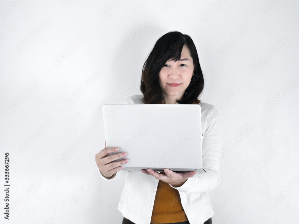 Happy Asian woman using laptop against the wall, lifestyle concept. Happy Asian woman using laptop against the wall, lifestyle concept.