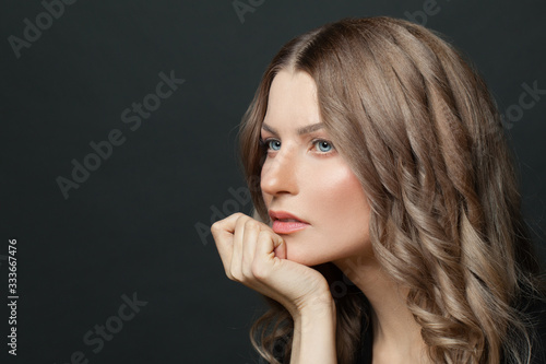 Woman thinking on black background portrait