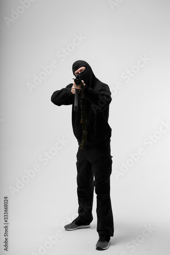 Man in mask With gun on white background