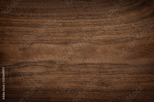 Walnut wooden chopping board texture background. Old wooden chopping board with knife pattern.