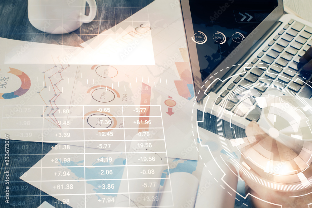 Double exposure of stock graph with businessman typing on computer in office on background. Concept of hard work. Double exposure of stock graph with businessman typing on computer in office on background. Concept of hard work.