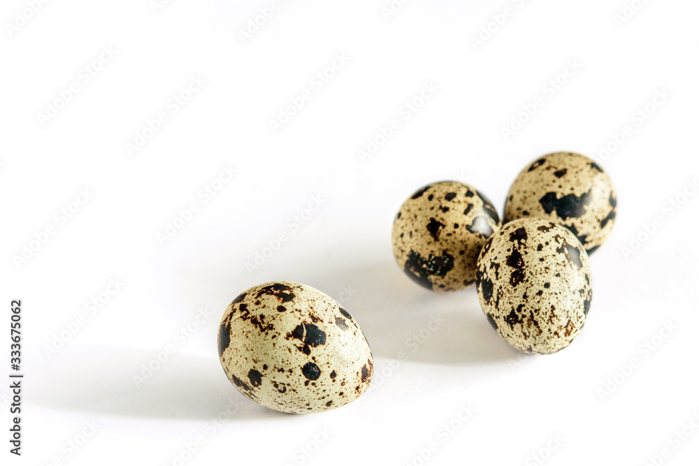 Quail spotted eggs closeup isolated on the white background. Healthy diet food. Macro. Quail spotted eggs closeup isolated on the white background. Healthy diet food. Macro.