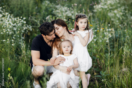 Happy young family spending time together outside in green nature © kalinichenkod