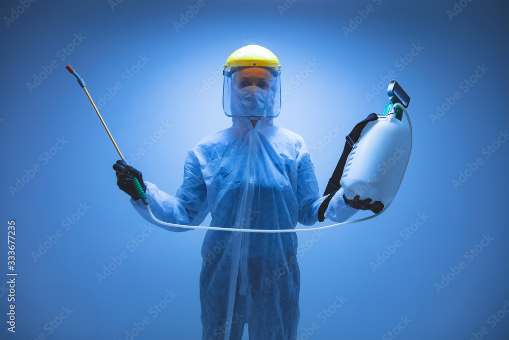 Scientist holding chemical sprayer for sterilization and