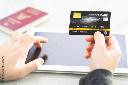 Close up of women hand holding credit card with tablet computer blank space screen