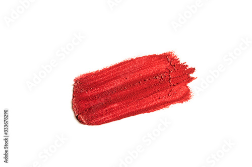 Lipstick swatch smudge smear isolated on white background. Cream makeup texture. Red color cosmetic product brush stroke swipe sample