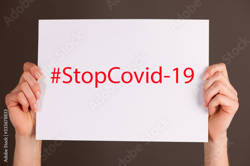 White board -with text srop covid-19 #stopcovid19 photo