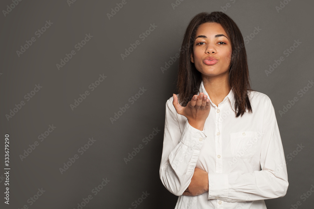 Smiling mixed race ethnicity young woman blowing kiss Smiling mixed race ethnicity young woman blowing kiss