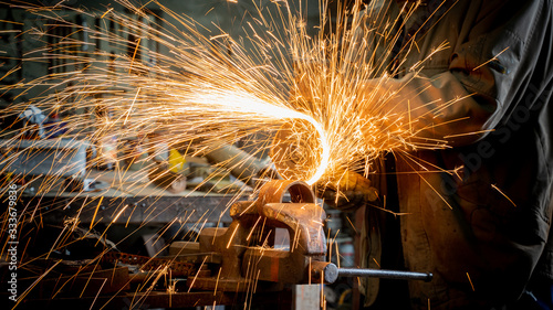 angle grinder at action sparks when cutting metal