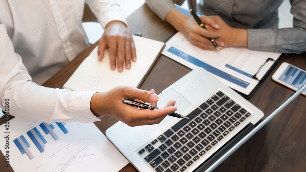 Business team brainstorming and discussing with financial data and report graph. Teamwork meeting working concept. Business team brainstorming and discussing with financial data and report graph. Teamwork meeting working concept.