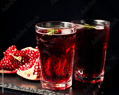 Pomegranate juice on a dark background. Summer drink. Pomegranate on a dark background.