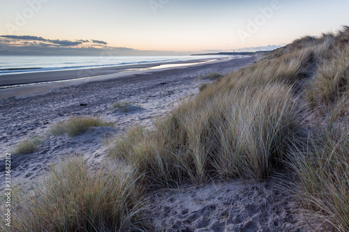 View of Druridge Bay Beach, an area of outstanding natural beauty on the coast of Northumberland, England, UK. At dawn in early morning light.