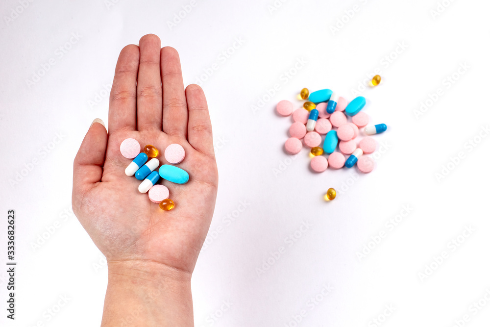 Colorfull medicine pills in left hand. blue, rose and yellow medicines and vitamins Colorfull medicine pills in left hand. blue, rose and yellow medicines and vitamins