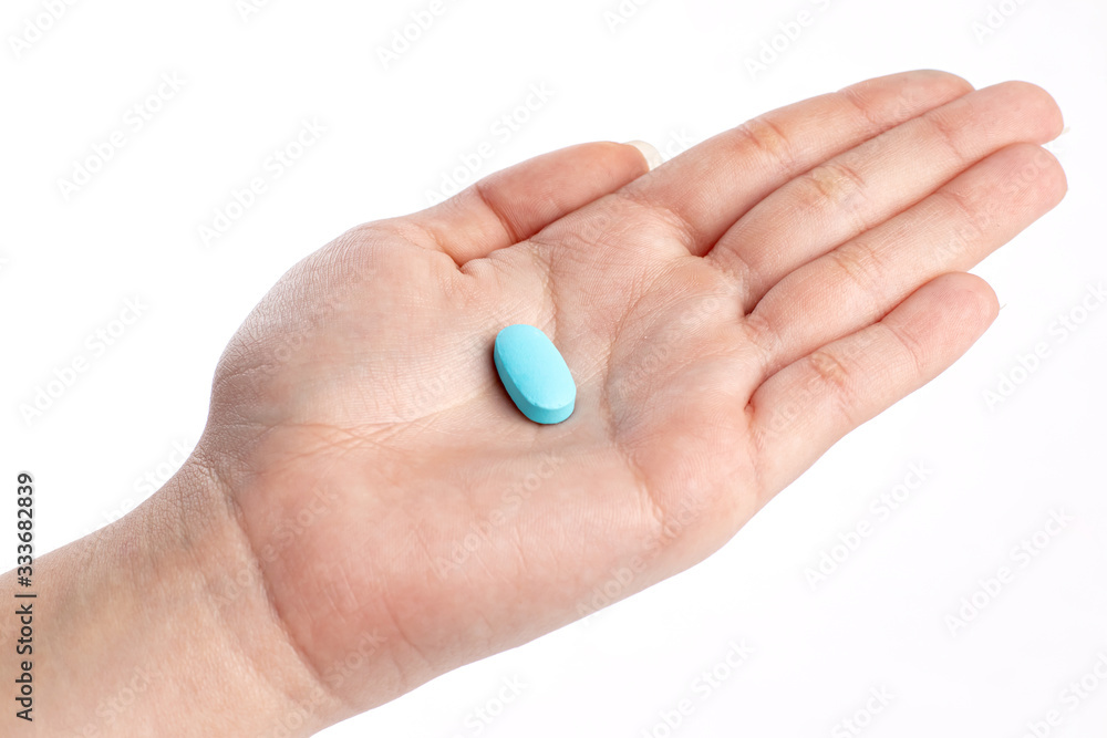 Blue vitamine in hand. medicines and vitamins Blue vitamine in hand. medicines and vitamins