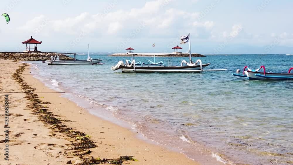 Slowmotion shot of traditional Jukung boats in Bali, Indonesia. Fantastic Bali sandy beach and coastline Slowmotion shot of traditional Jukung boats in Bali, Indonesia. Fantastic Bali sandy beach and coastline