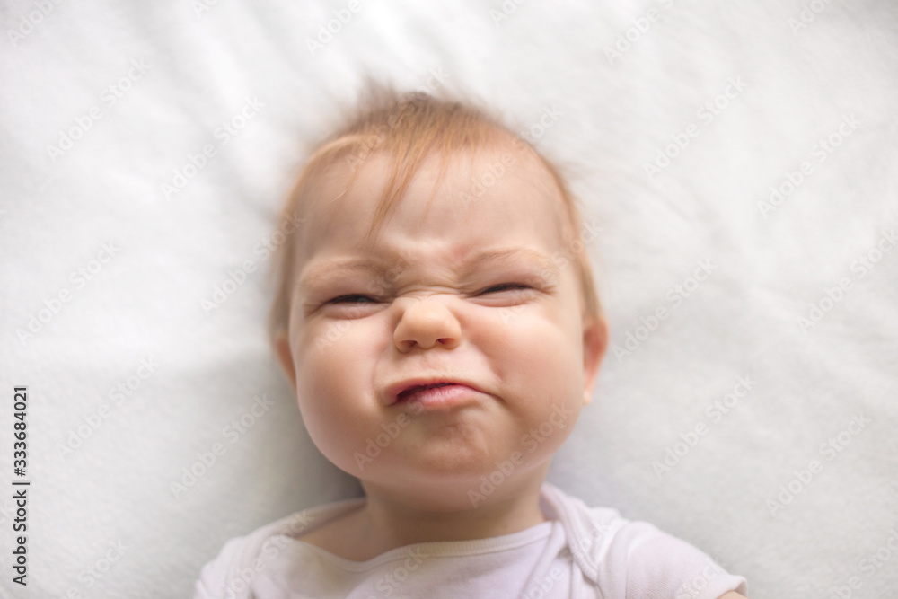 baby in white clothes on the bed baby in white clothes on the bed