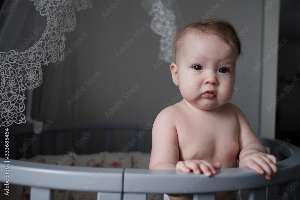 Cute little baby stand in crib at home. Cute little baby stand in crib at home.