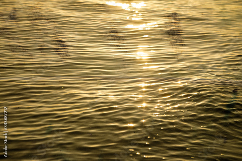 Yellow sea wave texture, beatiful golden sunrise.