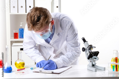 doctor in the lab takes notes in a notebook