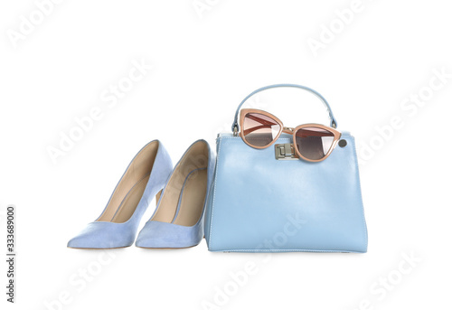 Stylish blue woman's bag, shoes and sunglasses isolated on white