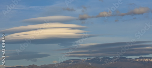 Huge white lenticular clouds over Sierra Nevada in Granada